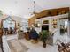 Spacious living room with high ceilings, built-in shelving, and a large TV at 4472 Via Del Villetti Dr, Venice, FL 34293