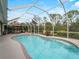 Enjoy this refreshing kidney-shaped pool with a screened enclosure at 4472 Via Del Villetti Dr, Venice, FL 34293