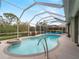 Relaxing kidney-shaped pool with a spa and screened enclosure at 4472 Via Del Villetti Dr, Venice, FL 34293