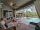 Relaxing pool area with wicker furniture and covered lanai at 4472 Via Del Villetti Dr, Venice, FL 34293