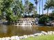 Serene waterfall feature with lush landscaping at 4472 Via Del Villetti Dr, Venice, FL 34293