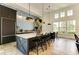 Community kitchen with dark cabinetry, quartz countertops and patterned backsplash at 4514 Big Woods Way, Parrish, FL 34219