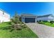 Gray house with paver driveway and nicely landscaped yard at 4514 Big Woods Way, Parrish, FL 34219