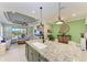 Island kitchen with granite countertops, stainless steel appliances, and open layout at 4514 Big Woods Way, Parrish, FL 34219