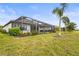 Backyard view of home with screened patio and landscaping at 4534 Trento Pl, Bradenton, FL 34211