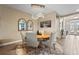 Bright dining room featuring a round wooden table and stylish chandelier at 4534 Trento Pl, Bradenton, FL 34211