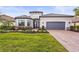 Single-story home with gray garage door and landscaped yard at 4534 Trento Pl, Bradenton, FL 34211