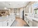 Spacious kitchen with white cabinets, farmhouse sink, and stainless steel appliances at 4534 Trento Pl, Bradenton, FL 34211