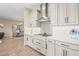 Kitchen with gas cooktop, modern range hood, and white shaker cabinets at 4534 Trento Pl, Bradenton, FL 34211