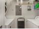 Convenient laundry room with washer, dryer, and shelving at 4802 51St W St # 1304, Bradenton, FL 34210