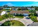 Aerial view of a single-Gathering home with circular driveway and canal access at 5011 Mangrove Point Rd, Bradenton, FL 34210