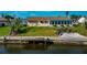 Aerial view of a home on the waterfront with a large sunroom and private dock at 5011 Mangrove Point Rd, Bradenton, FL 34210