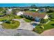 Aerial view of a single-Gathering home with a large driveway and landscaped yard at 5011 Mangrove Point Rd, Bradenton, FL 34210