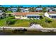 Aerial view of a home on the waterfront with a large sunroom and private dock at 5011 Mangrove Point Rd, Bradenton, FL 34210