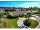 Aerial view of a single-Gathering home with circular driveway and canal access at 5011 Mangrove Point Rd, Bradenton, FL 34210
