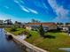 Aerial view of a home on the waterfront with a large sunroom and private dock at 5011 Mangrove Point Rd, Bradenton, FL 34210