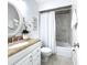 Clean bathroom with granite countertop, white cabinets, and shower/tub combo at 5011 Mangrove Point Rd, Bradenton, FL 34210