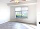 Simple bedroom with large window and tiled floor at 5011 Mangrove Point Rd, Bradenton, FL 34210