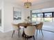 Charming dining area with round table and four beige chairs, and view of backyard at 5011 Mangrove Point Rd, Bradenton, FL 34210