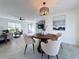 Bright dining area with wooden table and four chairs, along with a large piece of art at 5011 Mangrove Point Rd, Bradenton, FL 34210
