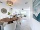 Open dining area with wooden table and chairs, offering a view of the living room at 5011 Mangrove Point Rd, Bradenton, FL 34210