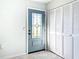 Bright entryway with a stylish, light blue door and built-in storage at 5011 Mangrove Point Rd, Bradenton, FL 34210