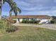 Tan house exterior, two-car garage, and landscaping at 5011 Mangrove Point Rd, Bradenton, FL 34210