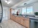 Modern kitchen with light wood cabinets and stainless steel appliances at 5011 Mangrove Point Rd, Bradenton, FL 34210