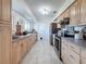 Modern kitchen with light wood cabinets and stainless steel appliances at 5011 Mangrove Point Rd, Bradenton, FL 34210