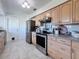 Modern kitchen with light wood cabinets and stainless steel appliances at 5011 Mangrove Point Rd, Bradenton, FL 34210