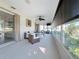 Bright sunroom features wicker furniture and relaxing canal views at 5011 Mangrove Point Rd, Bradenton, FL 34210