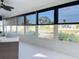 Bright sunroom features wicker furniture and relaxing canal views at 5011 Mangrove Point Rd, Bradenton, FL 34210