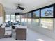 Bright sunroom features wicker furniture and relaxing canal views at 5011 Mangrove Point Rd, Bradenton, FL 34210