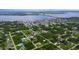 Aerial view showcasing a waterfront community with numerous houses and lush greenery at 5371 Fleming St, Port Charlotte, FL 33981