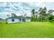 Large backyard with green grass and trees at 5371 Fleming St, Port Charlotte, FL 33981