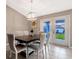 Bright dining room with table and chairs, leading to backyard at 5371 Fleming St, Port Charlotte, FL 33981