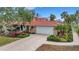 Two-story home with tile roof, landscaped yard, and driveway at 5376 Shadow Lawn Dr, Sarasota, FL 34242