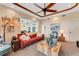 Relaxing living room featuring a comfortable leather sofa and a rustic coffee table at 5376 Shadow Lawn Dr, Sarasota, FL 34242