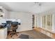 Spacious home office with built-in shelving and a large desk at 5376 Shadow Lawn Dr, Sarasota, FL 34242