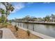 Waterfront property showcasing a canal view and a paved walkway at 5376 Shadow Lawn Dr, Sarasota, FL 34242
