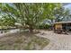 Spacious paver patio with seating area, fire pit, and mature landscaping at 5402 Shadow Lawn Dr, Sarasota, FL 34242