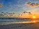 Stunning sunset over the ocean with sandy beach at 5402 Shadow Lawn Dr, Sarasota, FL 34242