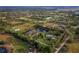 Aerial view of property showing house, pond, and surrounding land at 5645 Churchill Downs Rd, Sarasota, FL 34241