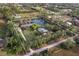 Aerial view of private property with picturesque pond, mature trees, and lush landscaping at 5645 Churchill Downs Rd, Sarasota, FL 34241