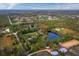 Aerial view of property showing house, pond, and surrounding land at 5645 Churchill Downs Rd, Sarasota, FL 34241