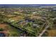Aerial view of property showing house, pond, and surrounding land at 5645 Churchill Downs Rd, Sarasota, FL 34241