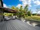 Spacious back deck with pergola, lush landscaping and seating at 5645 Churchill Downs Rd, Sarasota, FL 34241
