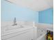 Simple bathroom with a bathtub and utility sink at 5645 Churchill Downs Rd, Sarasota, FL 34241