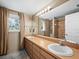 Bathroom with double vanity and large mirror at 5645 Churchill Downs Rd, Sarasota, FL 34241