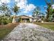House exterior showcasing a ranch-style home with a gravel driveway at 5645 Churchill Downs Rd, Sarasota, FL 34241
